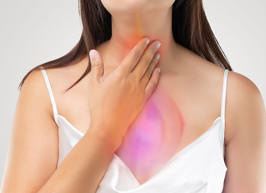 woman holding neck and chest from acid reflux