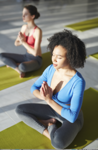 Two woman practising yoga