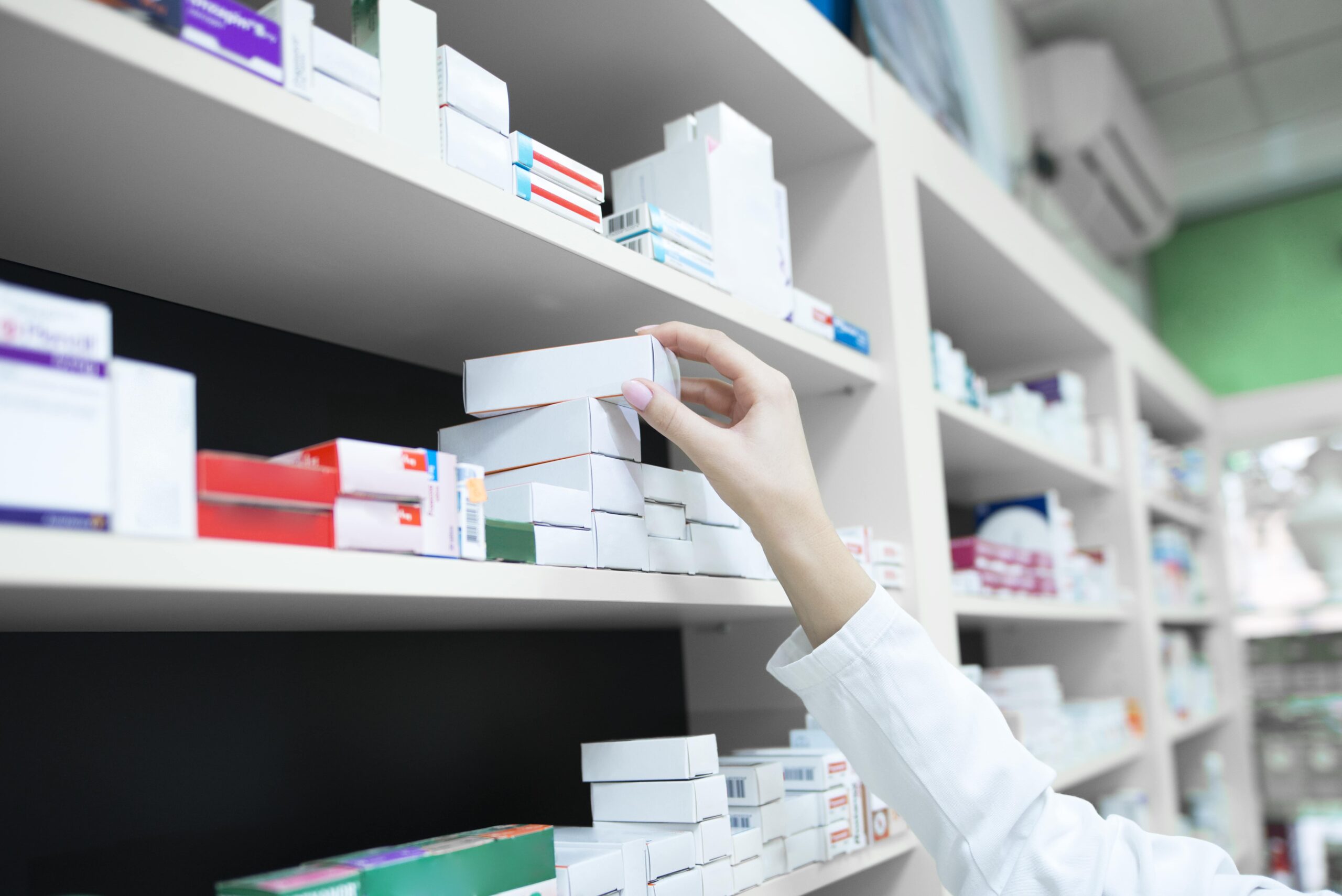 pharmacist reaching for medication