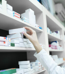 pharmacist reaching for medication